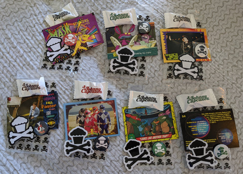 Set of 7 Johnny Cupcakes goody bags: pins, stickers, trading cards